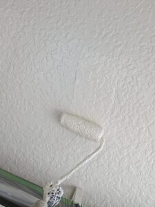 松本市A様邸 外壁上塗り作業の様子。最終仕上げとしてツヤと防水性を高める塗装を行っている。